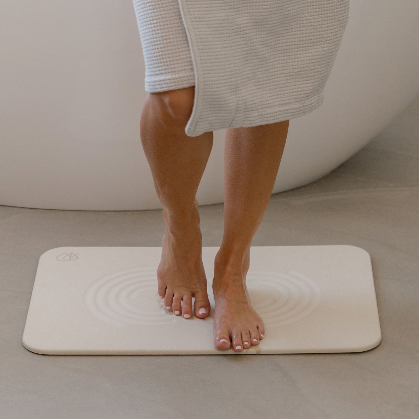 Original bath stone mat in Sandstone, quick-drying water from feet, in front of free-standing tub