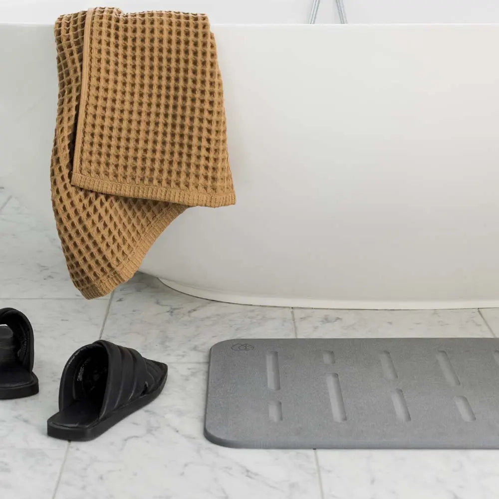 bathroom floor with rain stone mat from Dorai Home