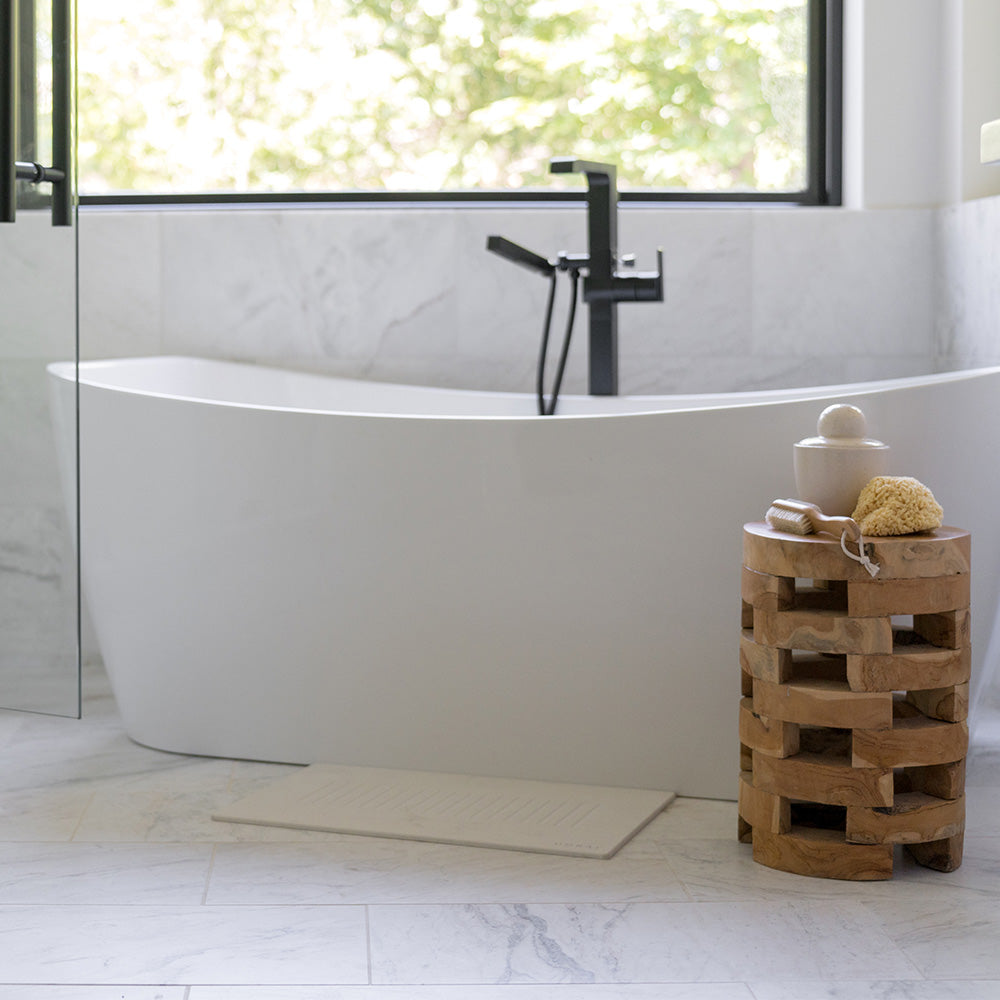 bathroom with stone bath mat