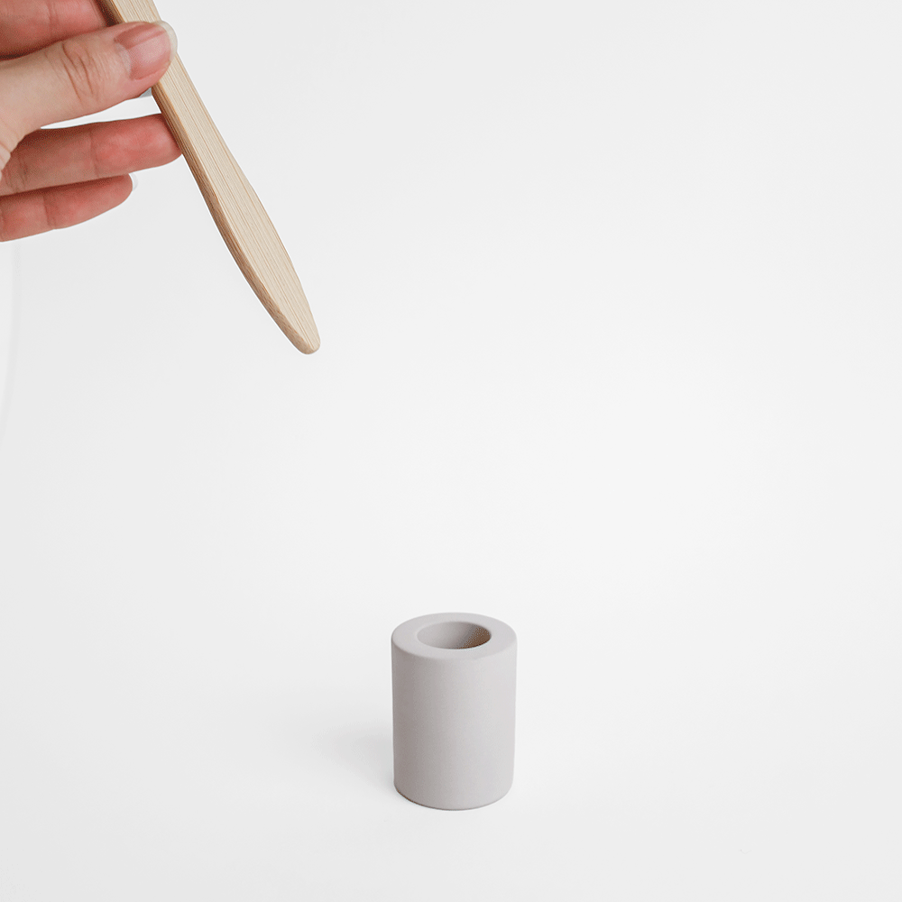 GIF of someone putting toothbrush into small toothbrush holder made from diatomaceous earth - Dorai Home