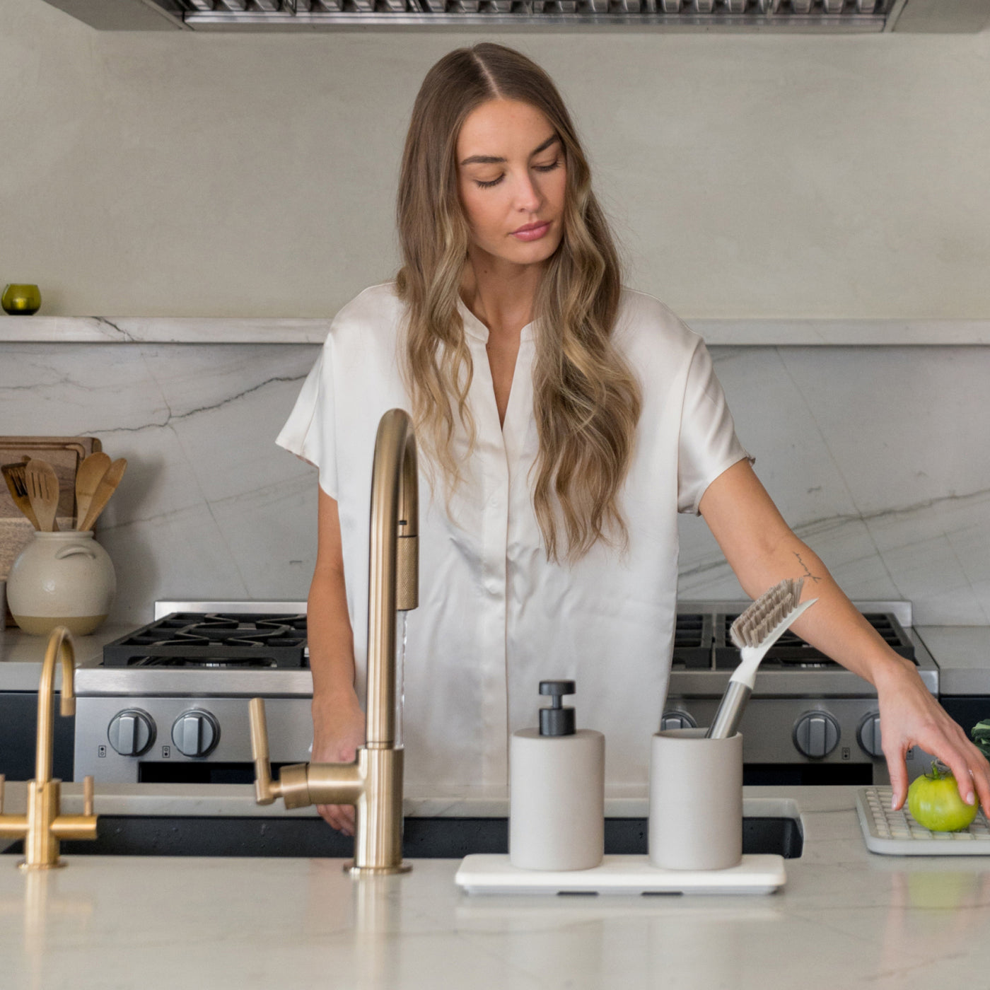 woman in kitchen with stone soap caddy - Dorai Home