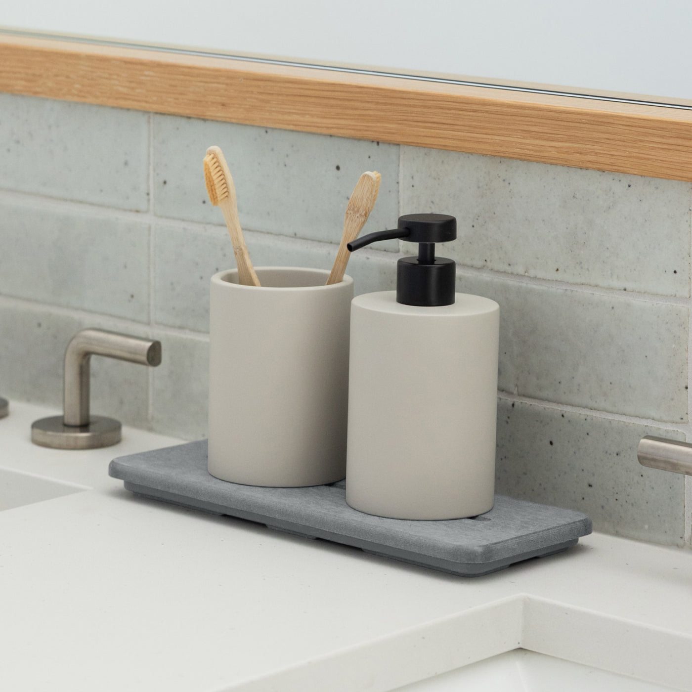 diatomaceous earth stone sink caddy with soap dispenser and brush holder in bathroom - Dorai Home
