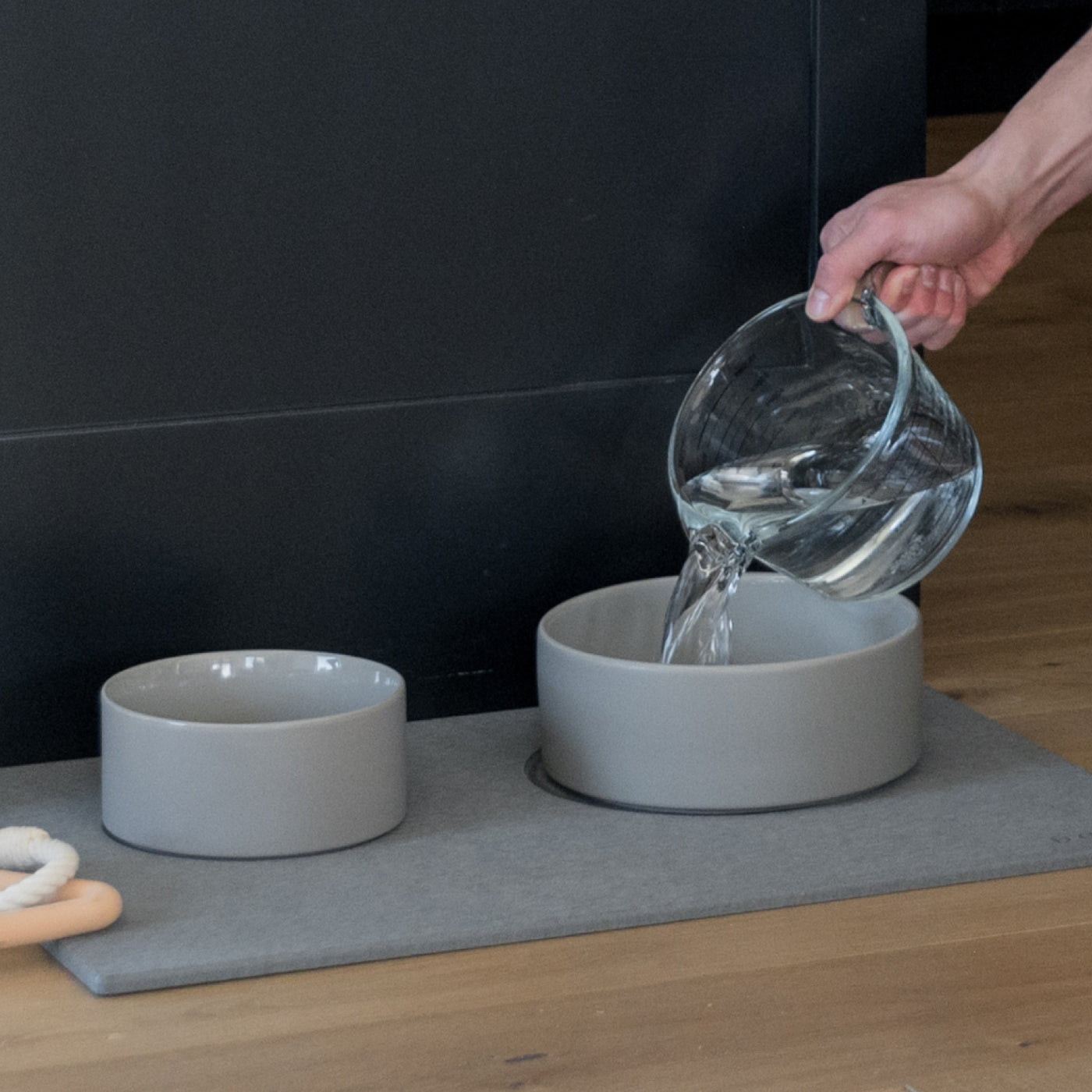 water being refilled into large ceramic water bowl