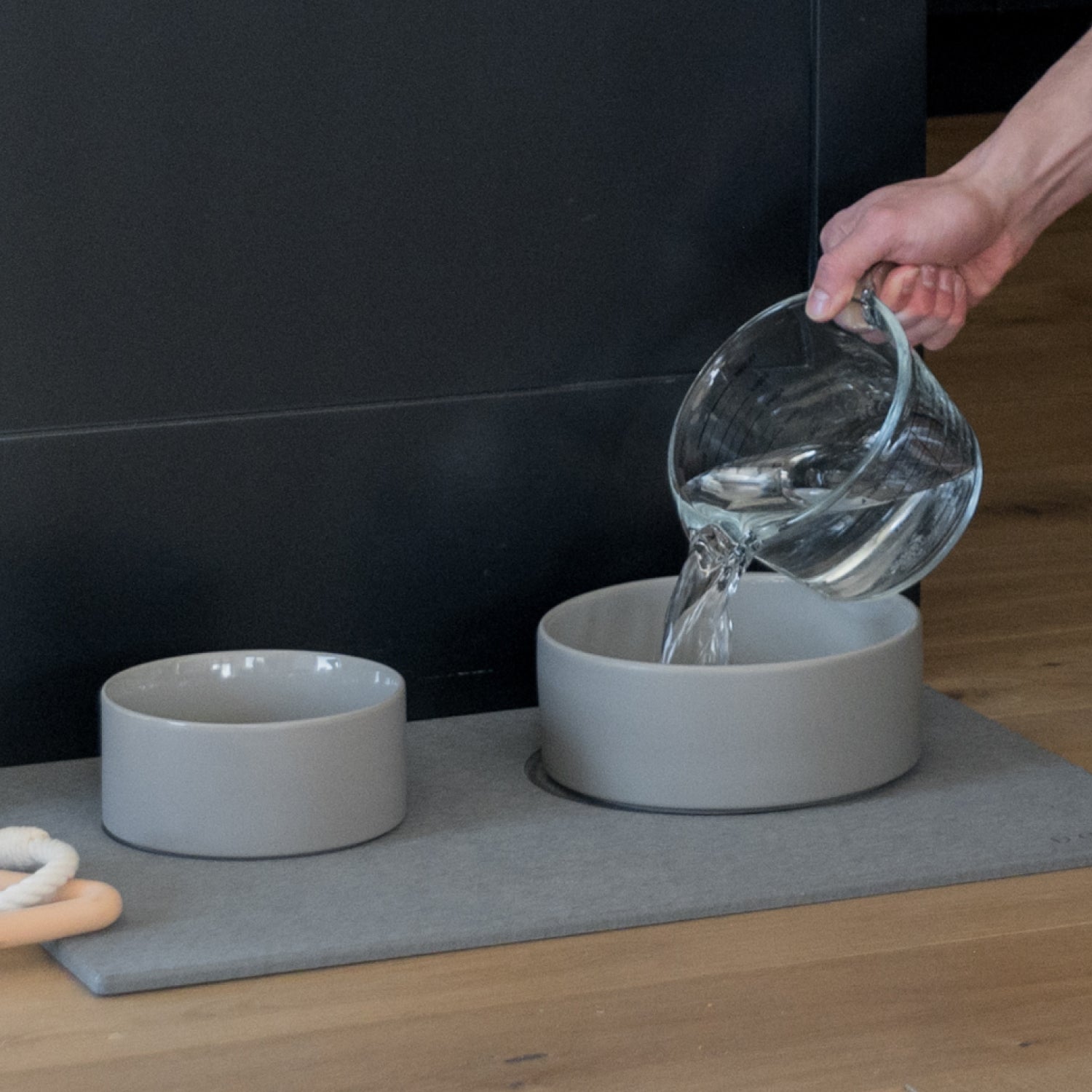water being refilled into large ceramic water bowl