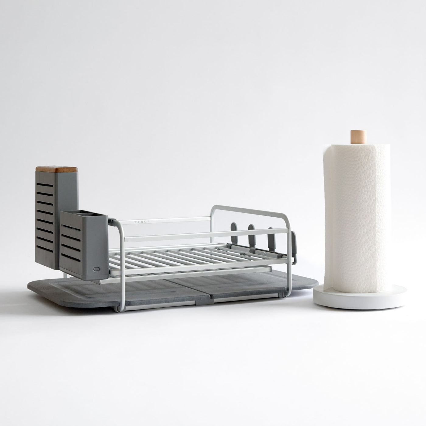silver dish rack with white paper towel holder