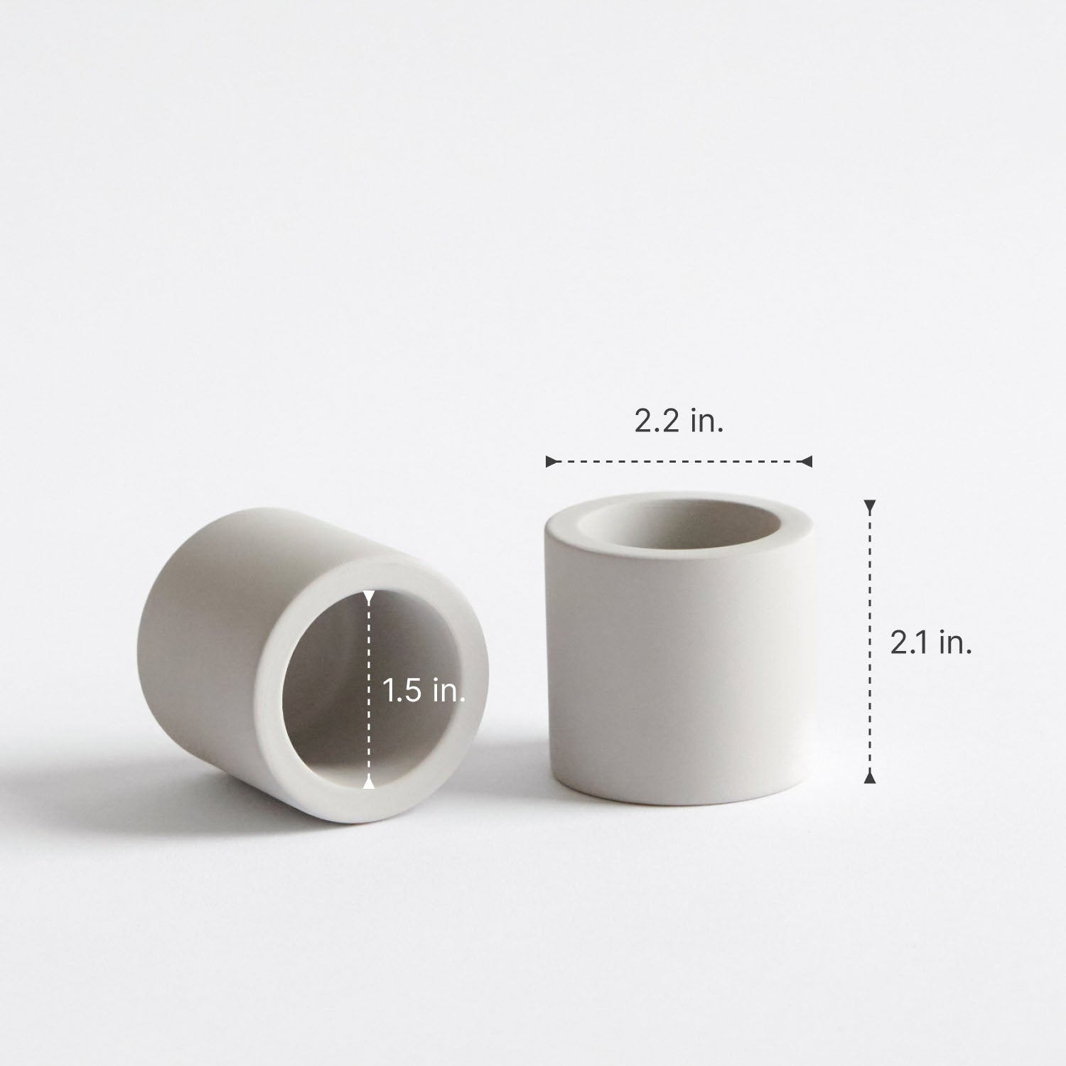 Two stone toothbrush holders with measurements on a white background