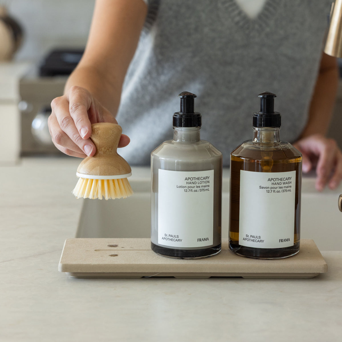 Clay Stone Sink Caddy with 2 soaps and dish scrubber.