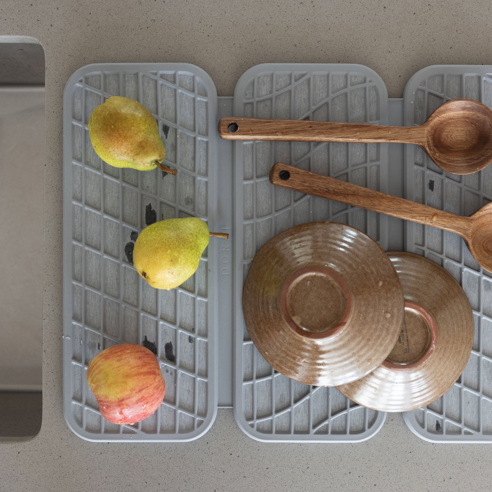 Drift Ash Dish Pad with produce, plates, and spoons.