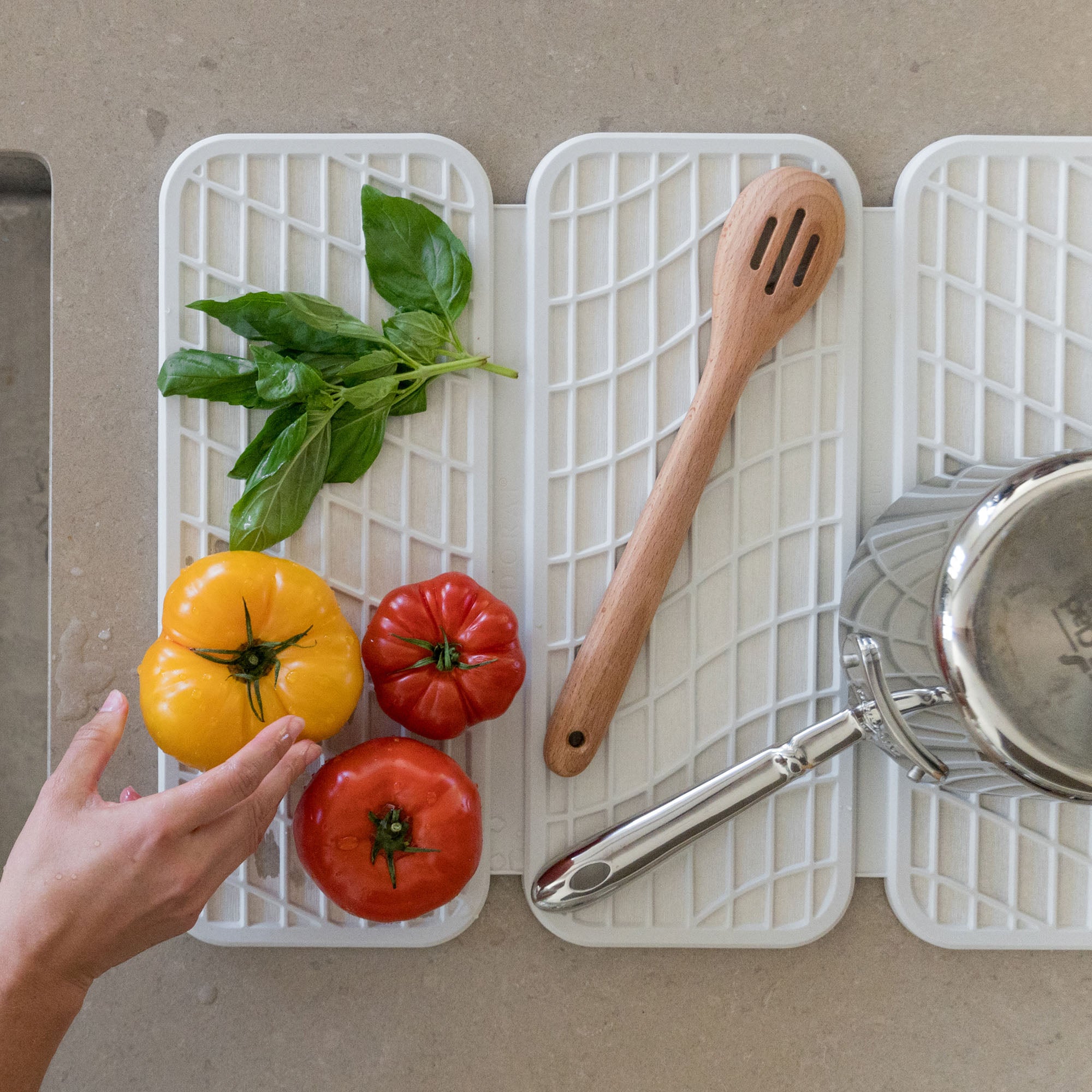 Drift Glacier Dish Pad with produce, pots, and cooking utensil.