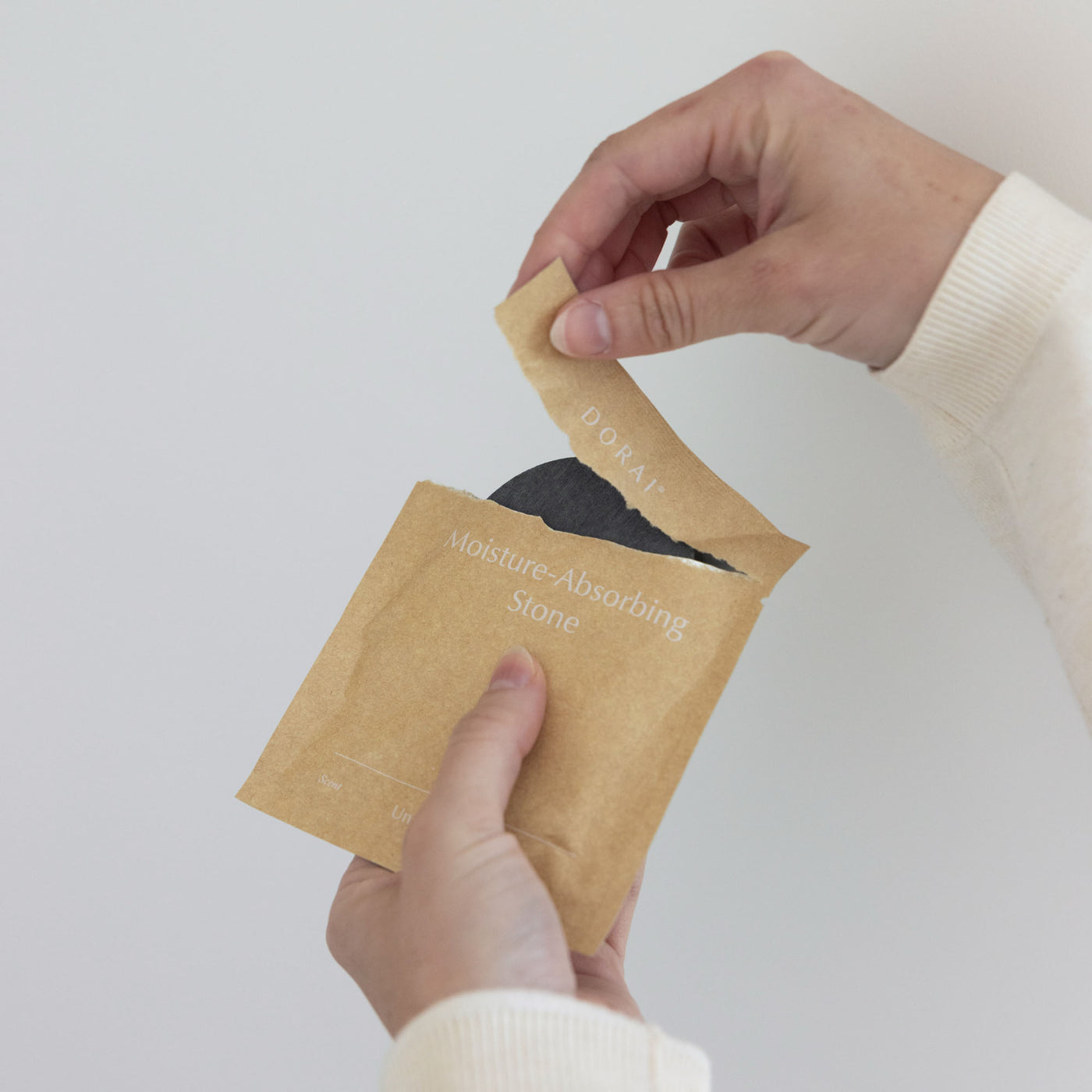 Person opening new unscented quick-drying stone. 