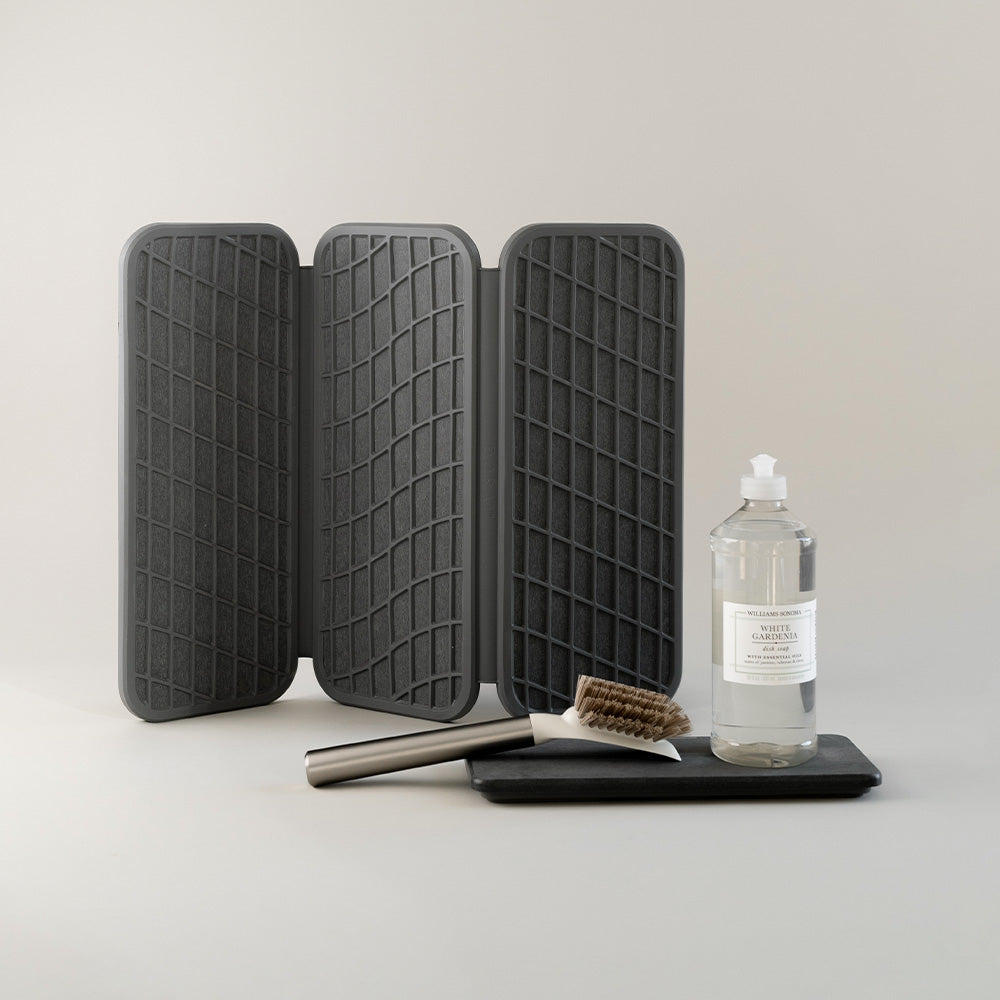 dish pad being folded with sink organizer in dark grey color