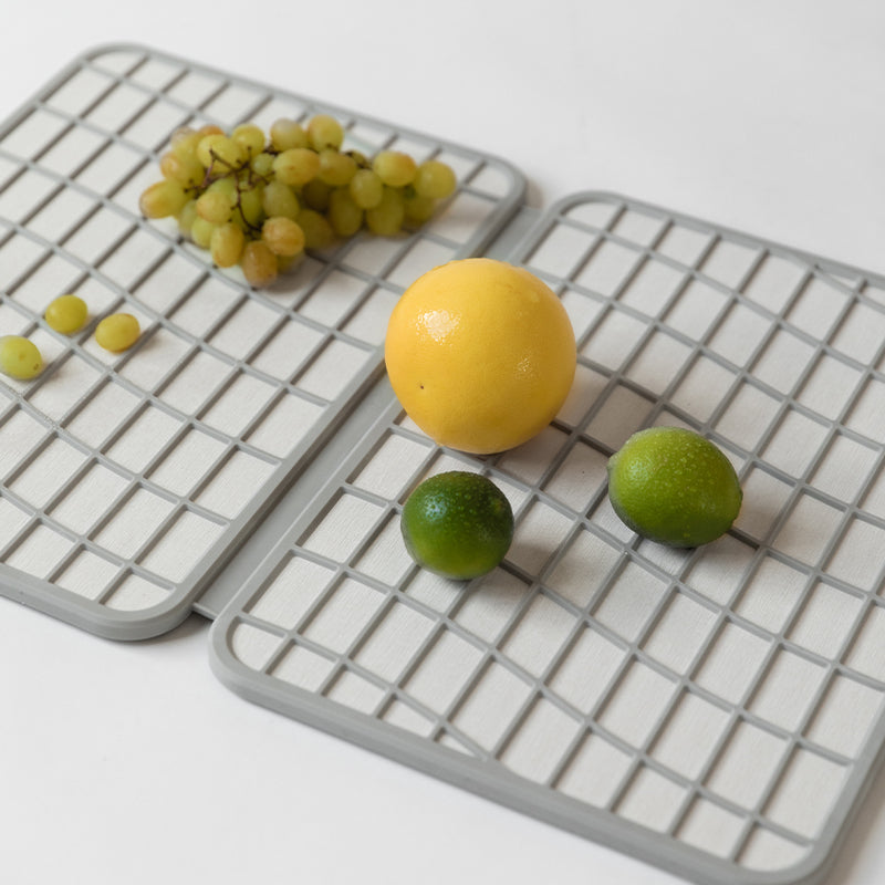 light grey dish drying stone mat with lemons and limes drying