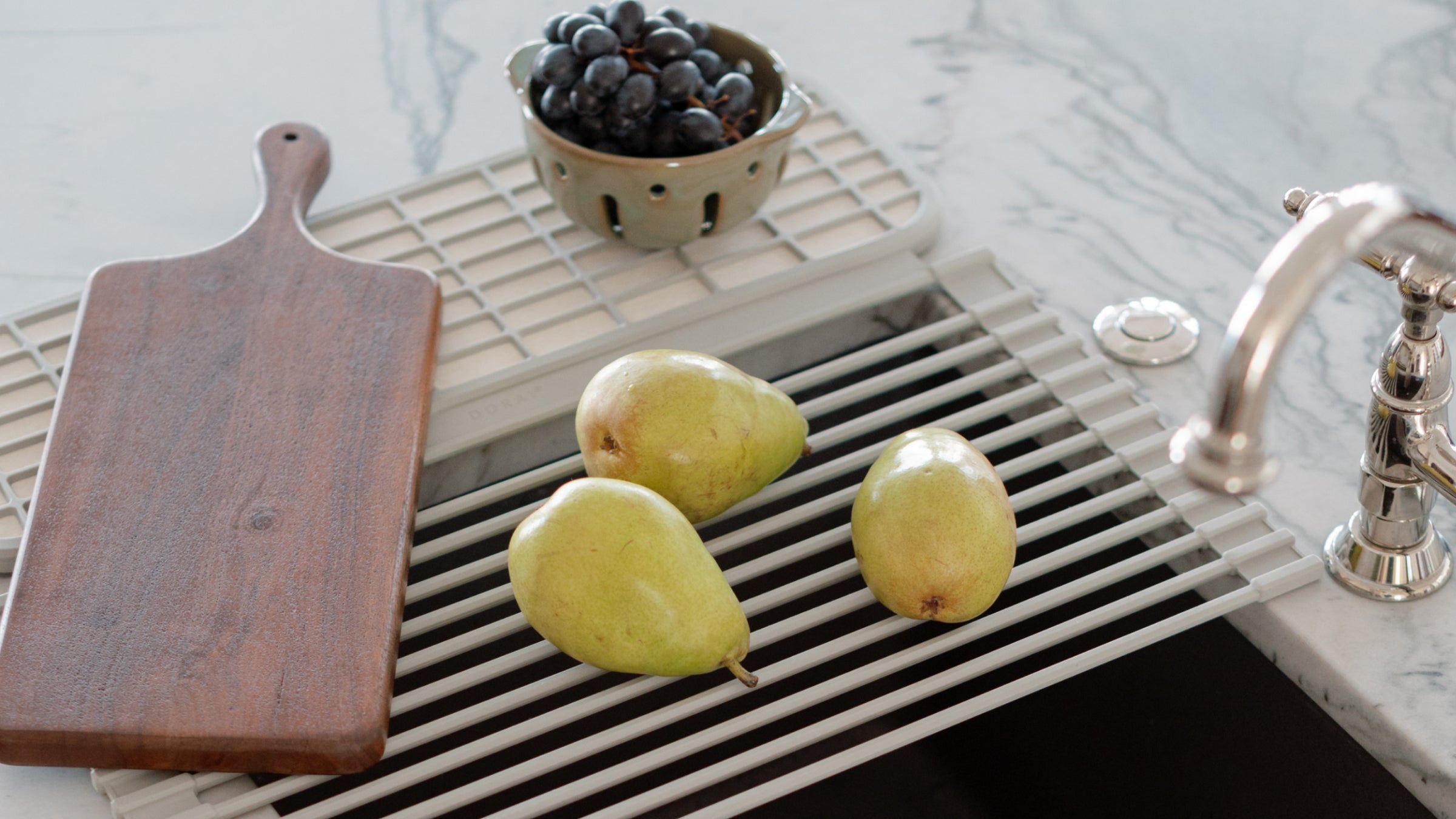 roll up dish drainer with fruit and cutting board