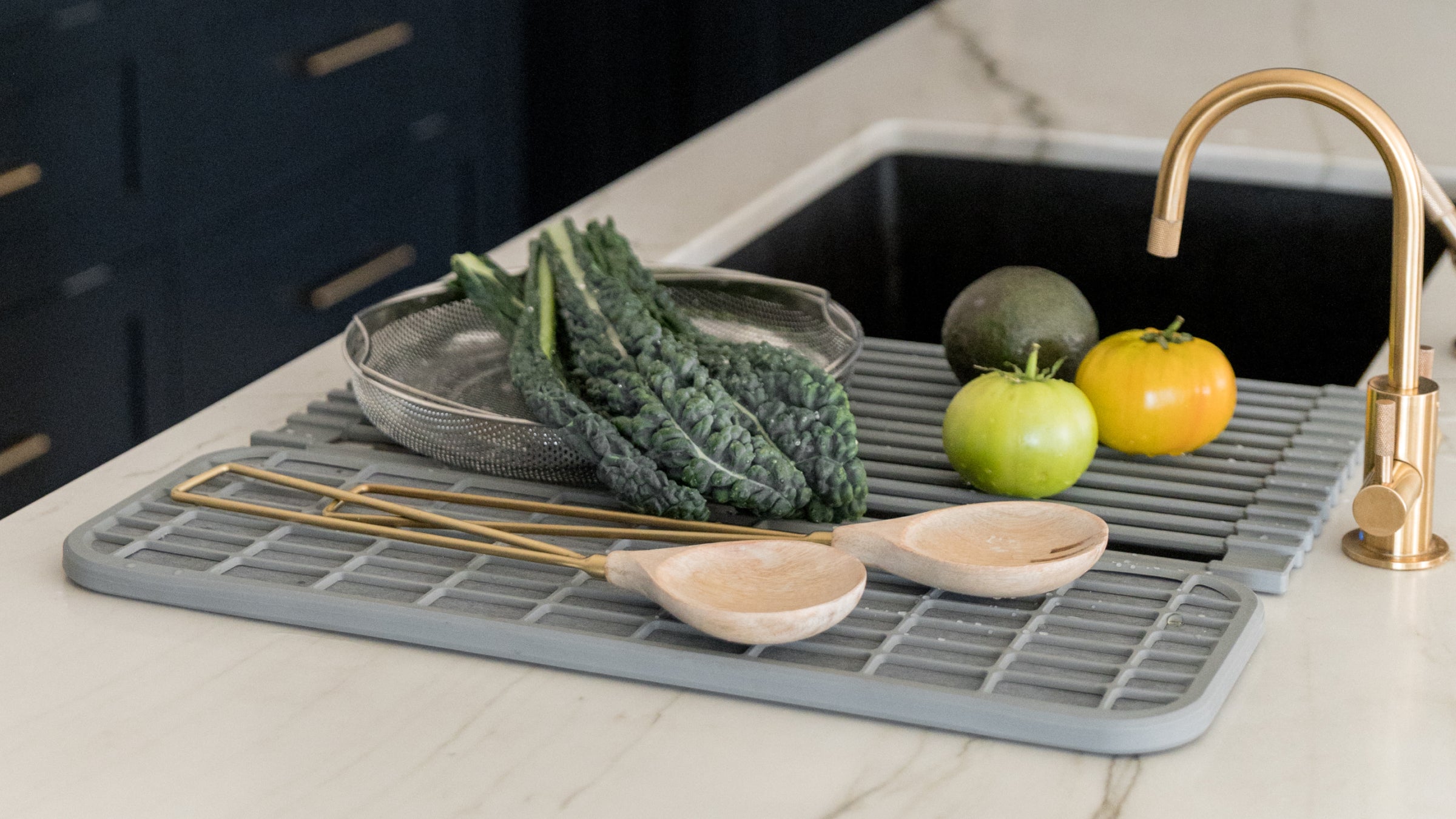vegetables and dishes drying on roll up drainer over the sink