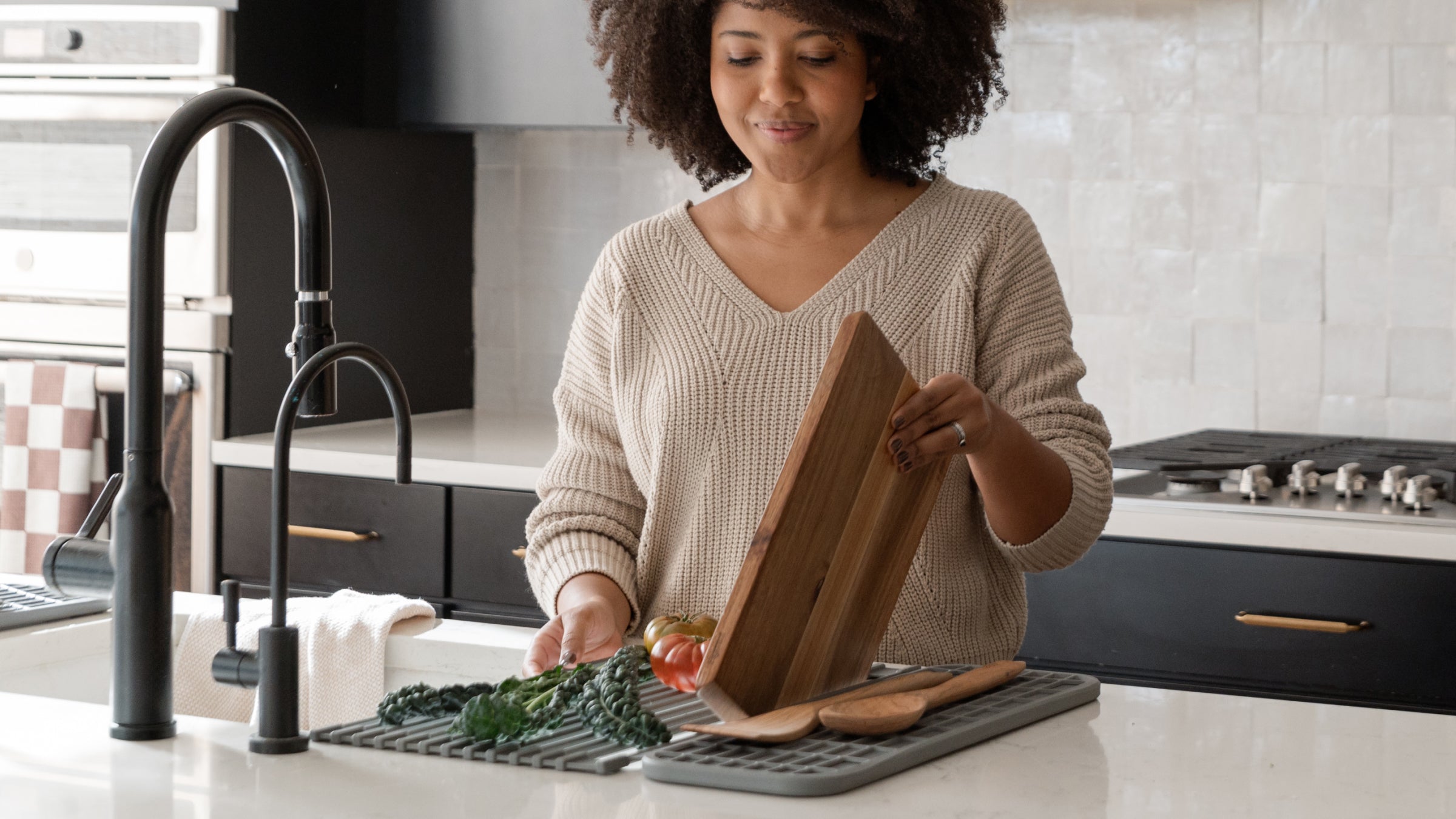 woman drying cutting board on over the sink roll outs dish mat