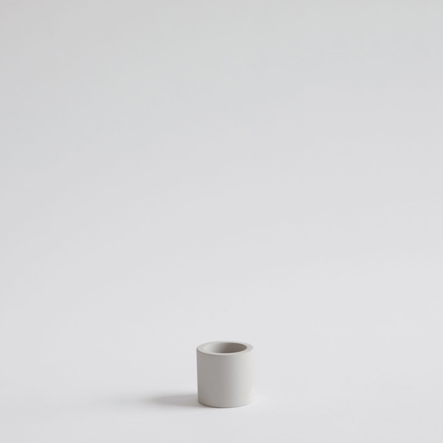 looping video of a hand placing an electric toothbrush into a stone toothbrush holder