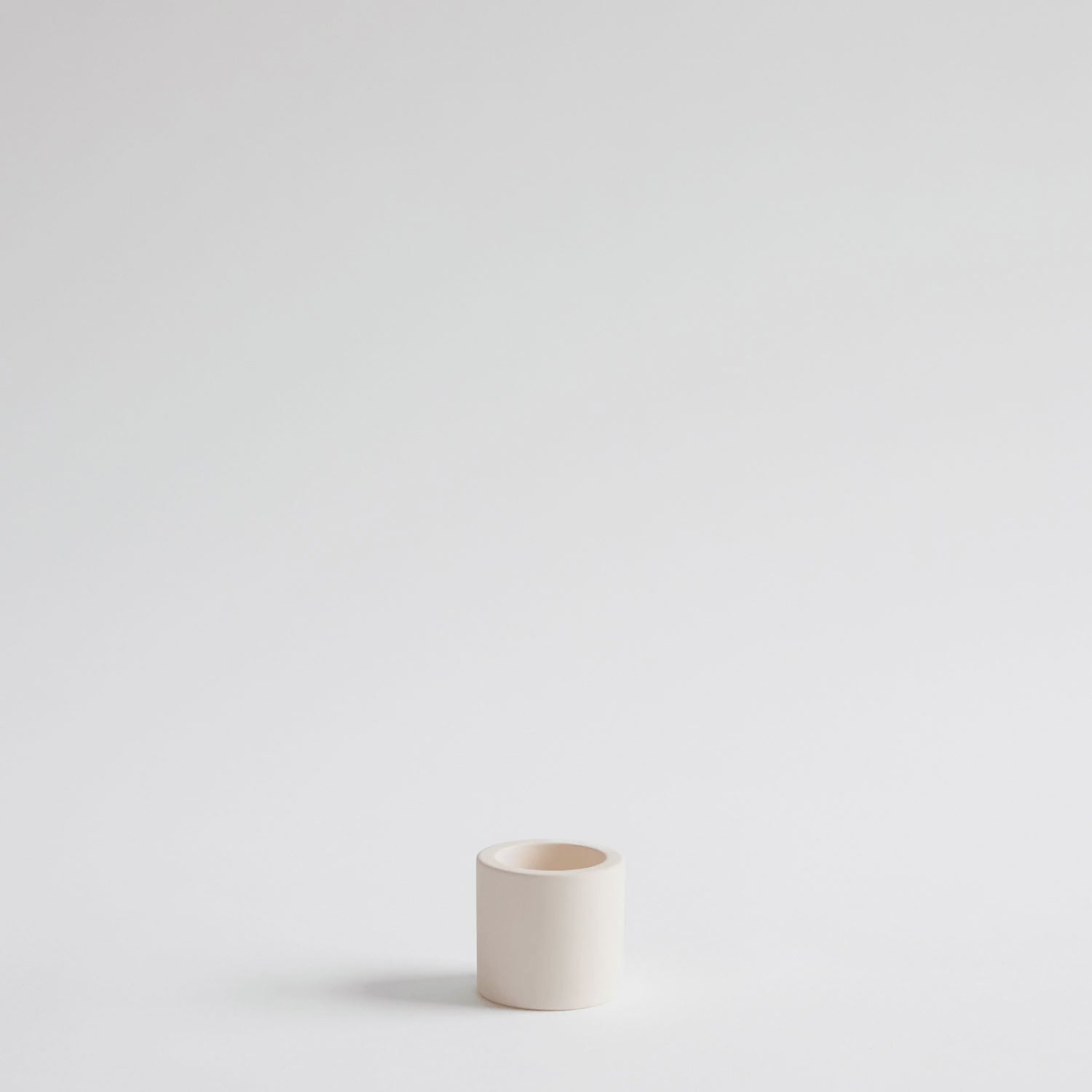 looping video of a hand placing an electric toothbrush into a stone toothbrush holder
