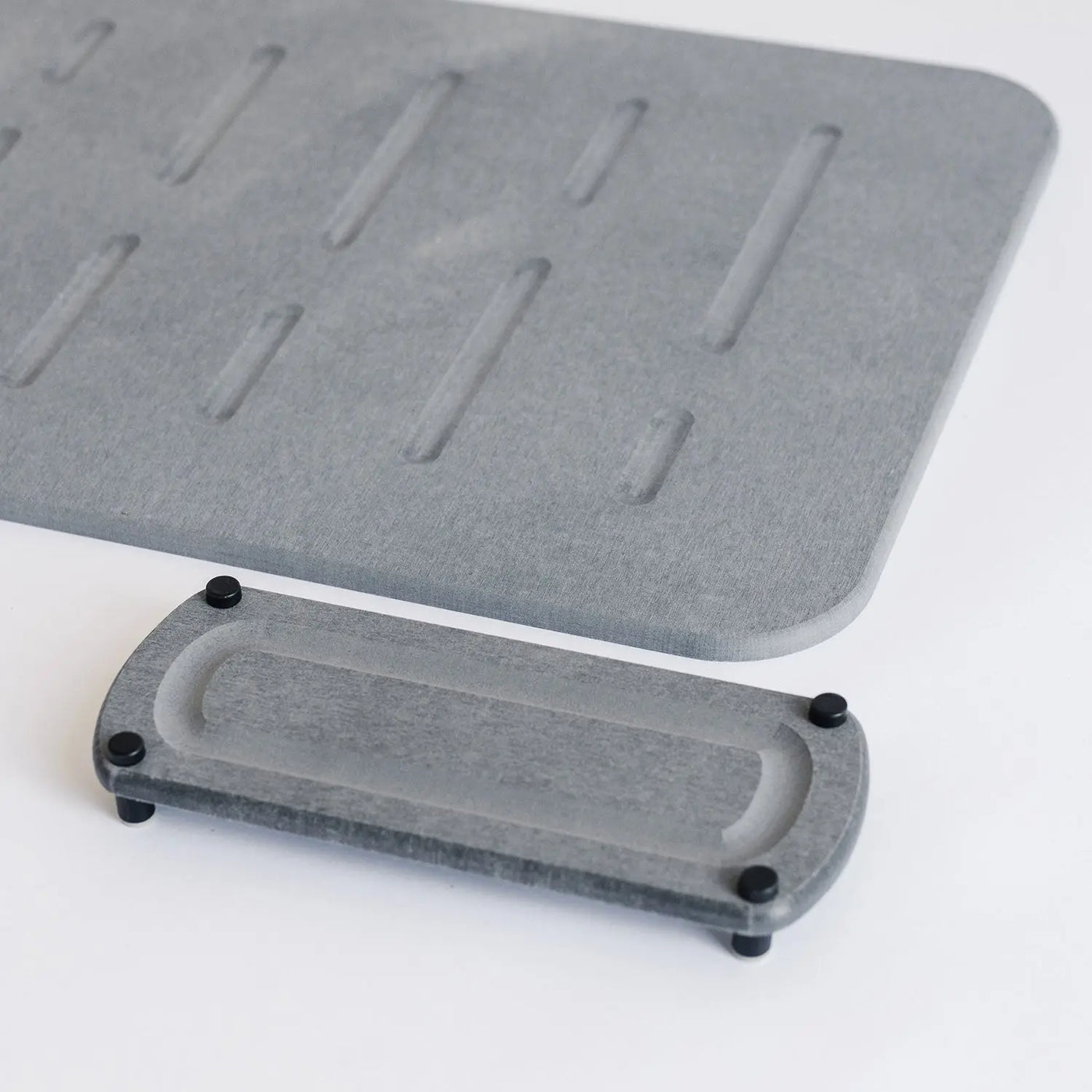 dark grey shower bath mat with elegant modern sink caddy with black metal feet