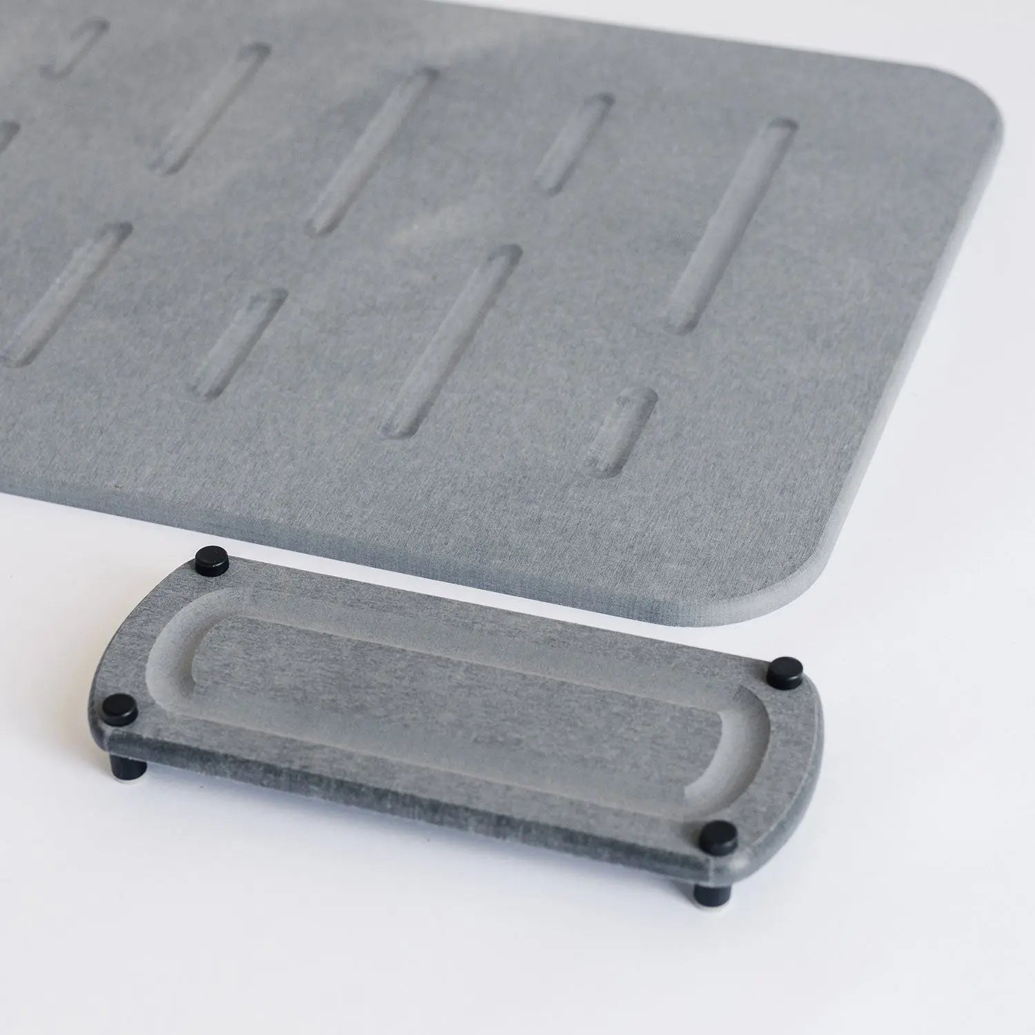 dark grey shower bath mat with elegant modern sink caddy with black metal feet
